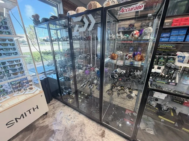 Rod racks and glass tackle cabinets near the windows