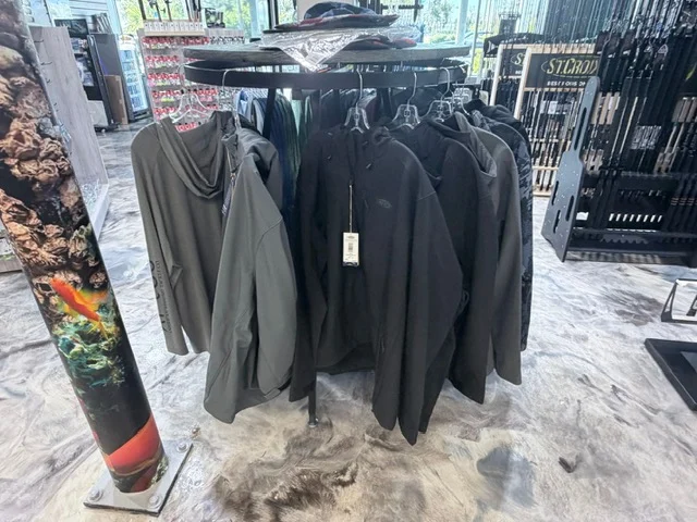 Fishing apparel hanging beside rod racks