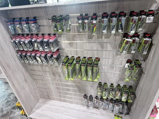 Fishing lures hanging in organized retail rows