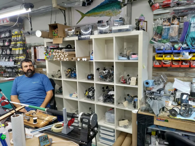 Staff member seated behind the shop counter