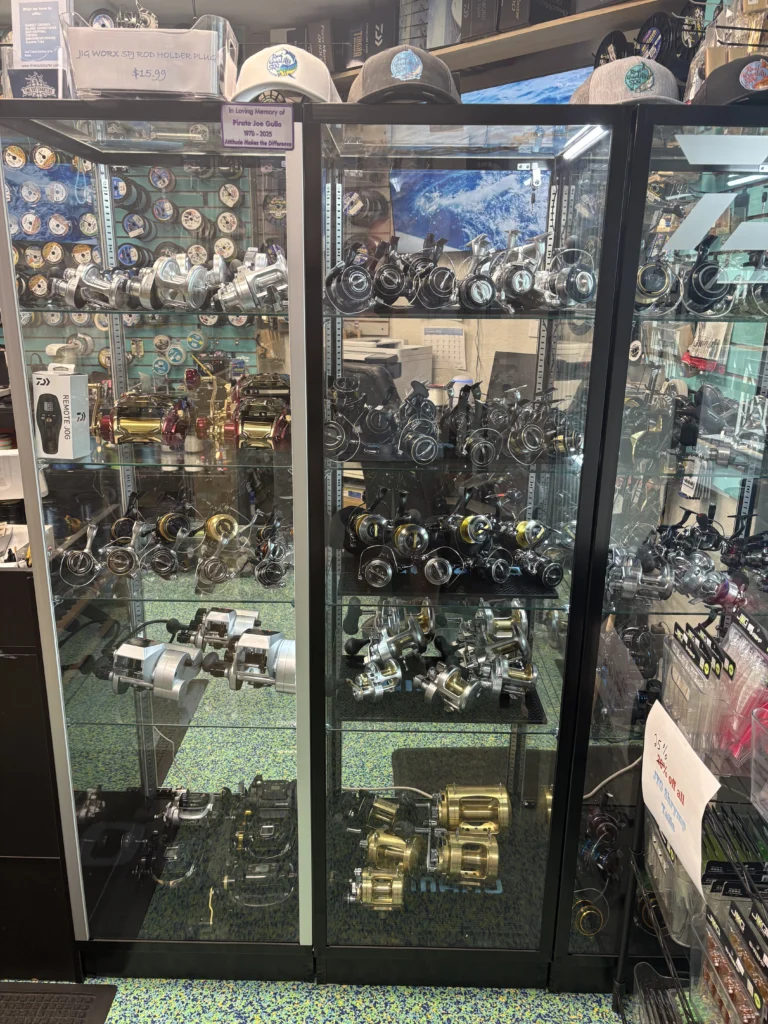 Glass display case holding fishing reels
