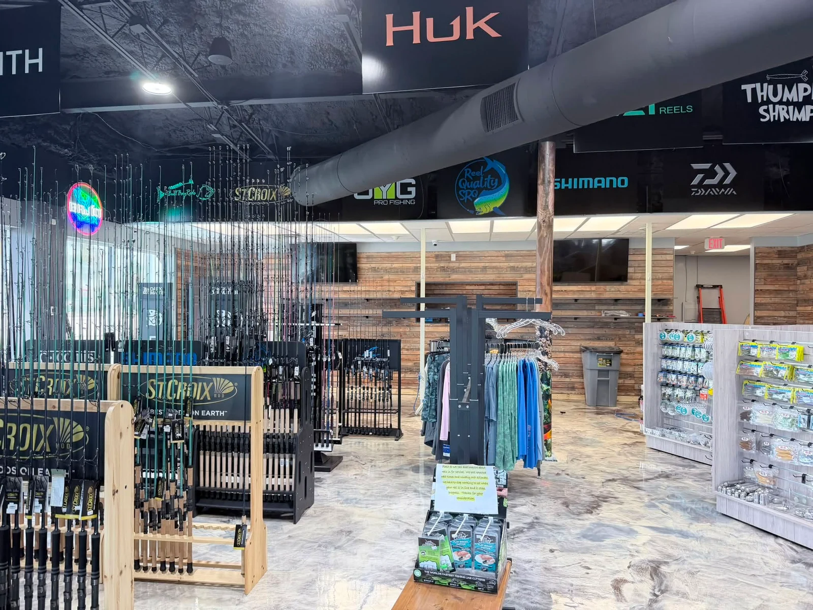 Fishing rod displays, apparel racks, and tackle inside Reel Quality SRQ in Nokomis, Florida.